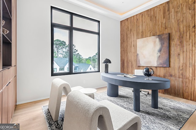office with wooden walls, wood finished floors, and baseboards