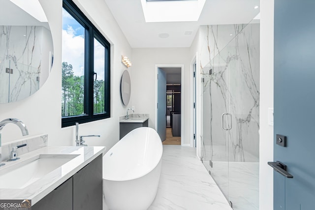 full bath featuring a marble finish shower, a sink, a freestanding bath, a skylight, and marble finish floor