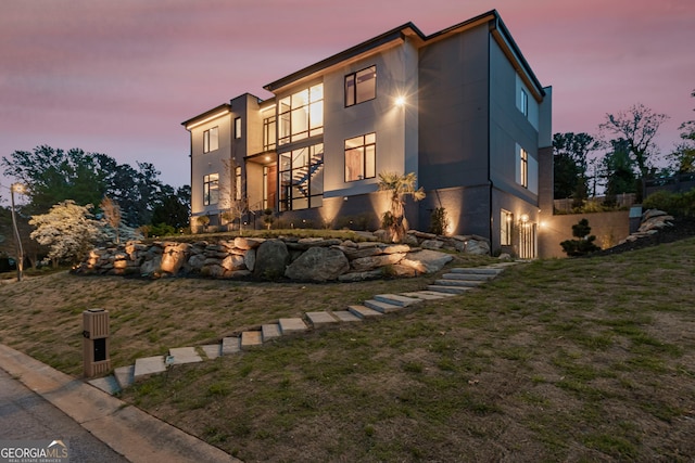 exterior space with a lawn and stucco siding