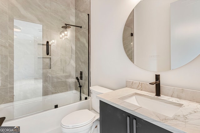 full bath featuring enclosed tub / shower combo, toilet, and vanity