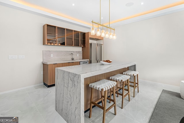 bar featuring high quality fridge, wet bar, a sink, decorative light fixtures, and baseboards