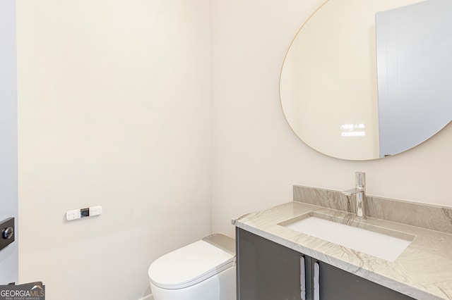 bathroom featuring toilet and vanity