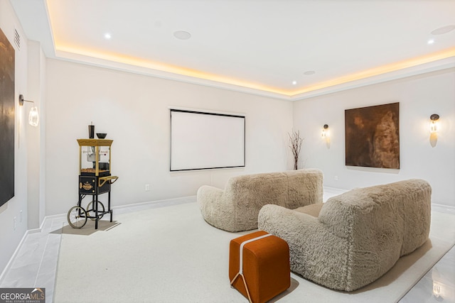 home theater with baseboards, a tray ceiling, and recessed lighting