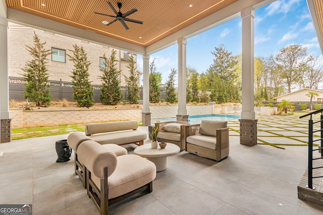 view of patio featuring a fenced in pool, a fenced backyard, and ceiling fan