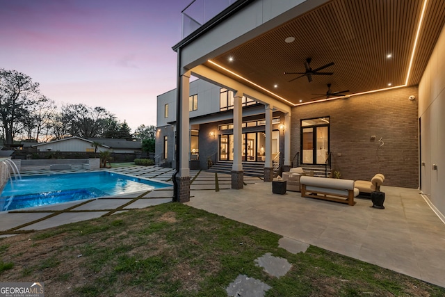 pool at dusk featuring a fenced in pool, a ceiling fan, entry steps, and a patio