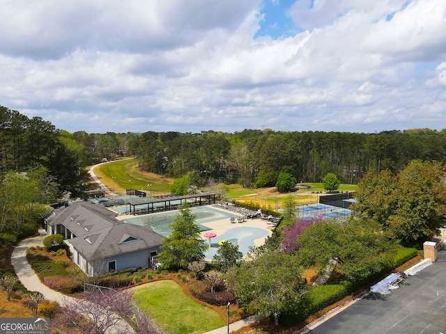 drone / aerial view with a wooded view