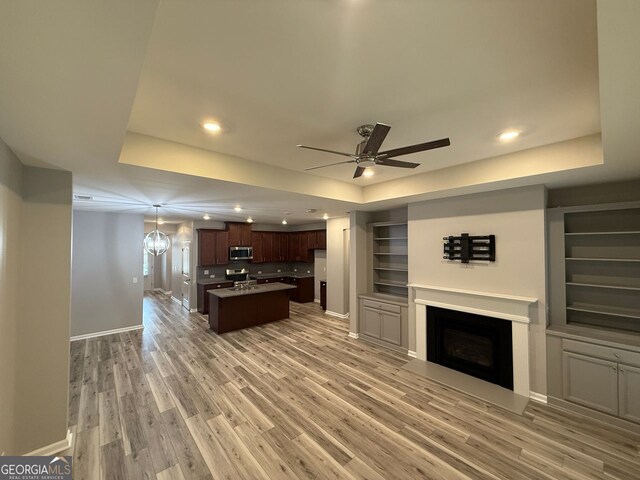 2460 Laurel Gate Ln, Cumming, GA 30040 - kitchen with decorative backsplash, appliances with stainless steel finishes, light wood-style flooring, and light stone counters