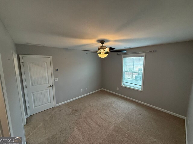 2460 Laurel Gate Ln, Cumming, GA 30040 - carpeted spare room with visible vents, a ceiling fan, and baseboards