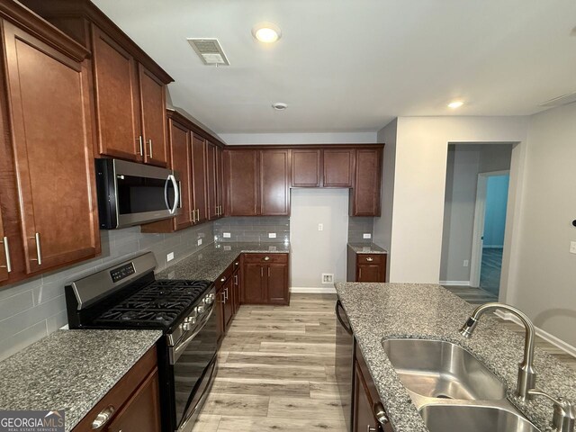2460 Laurel Gate Ln, Cumming, GA 30040 - kitchen with recessed lighting, a sink, visible vents, light wood-style flooring, and appliances with stainless steel finishes
