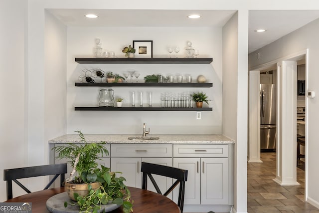 3772 Paces Ferry W SE, Atlanta, GA 30339 - indoor wet bar with freestanding refrigerator, recessed lighting, baseboards, and stone finish flooring