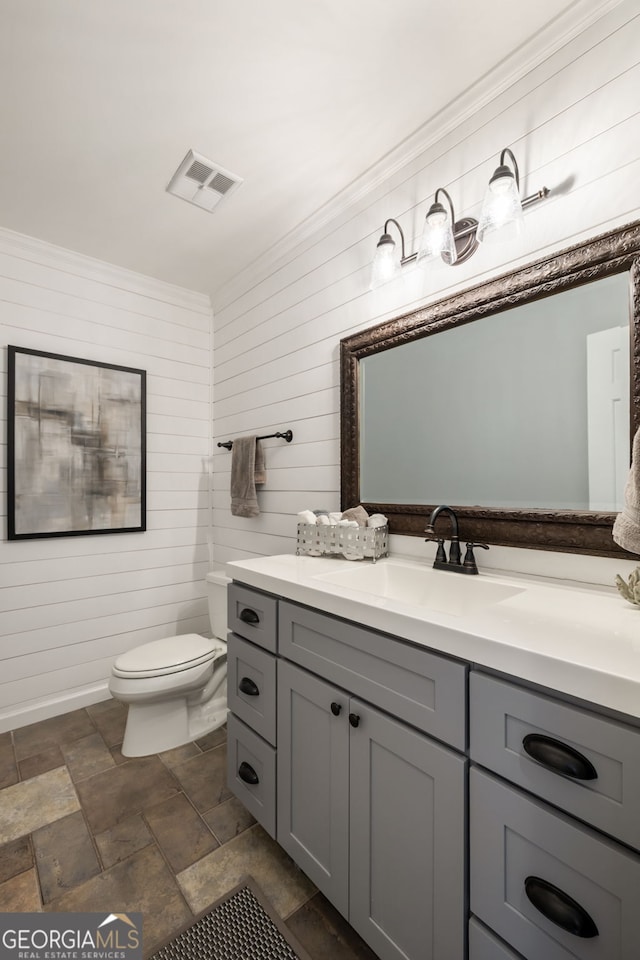 3772 Paces Ferry W SE, Atlanta, GA 30339 - bathroom featuring toilet, stone finish flooring, vanity, and wooden walls