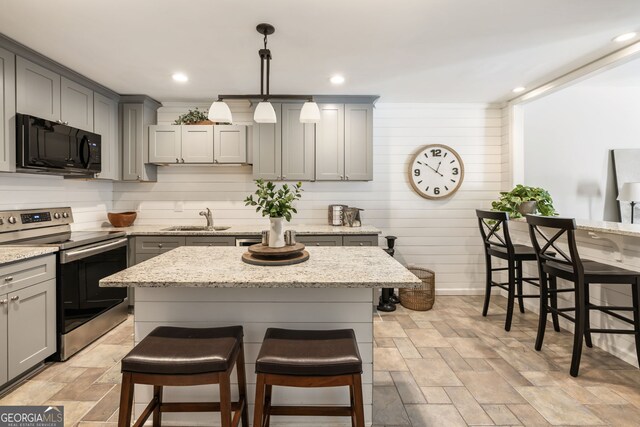 3772 Paces Ferry W SE, Atlanta, GA 30339 - kitchen featuring black microwave, stainless steel electric range, gray cabinets, a sink, and wood walls