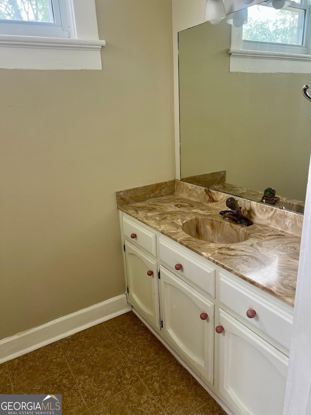 bathroom featuring baseboards and vanity