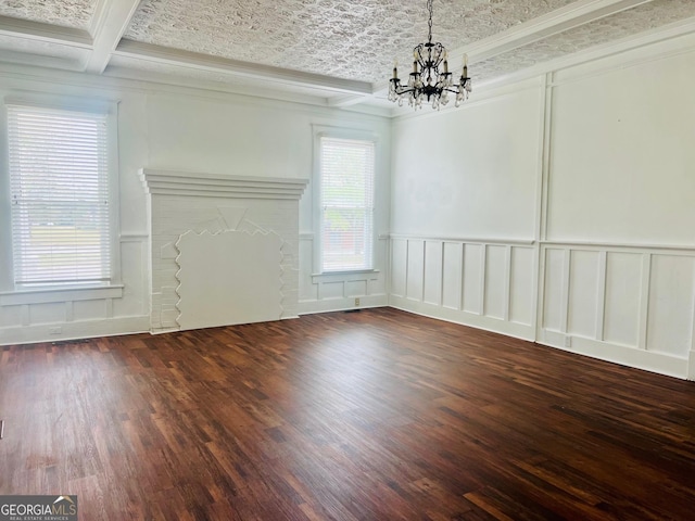 unfurnished dining area featuring wood finished floors, a decorative wall, beamed ceiling, ornamental molding, and an inviting chandelier