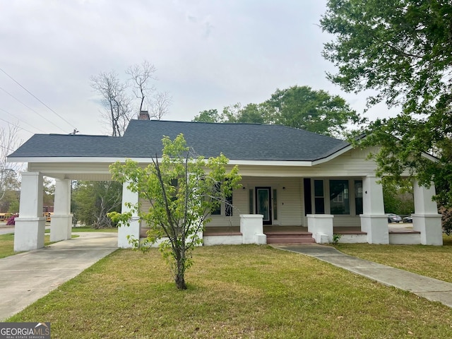 view of front of property with an attached carport, a shingled roof, a porch, and driveway