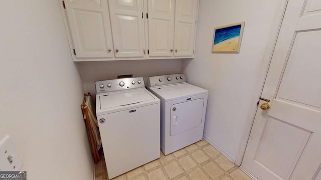 laundry room featuring baseboards, light floors, cabinet space, and washing machine and dryer
