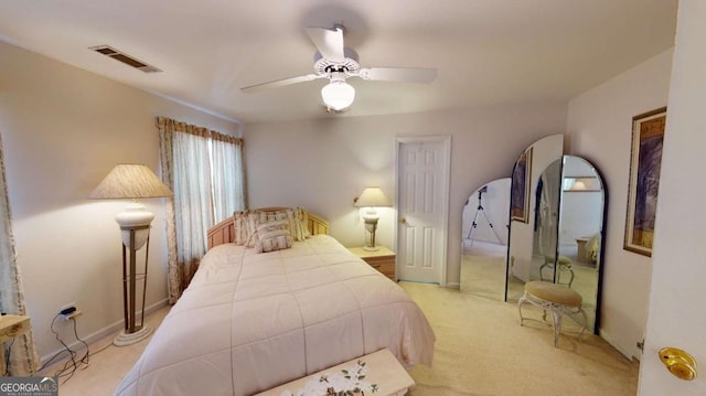 bedroom featuring visible vents, ceiling fan, and carpet