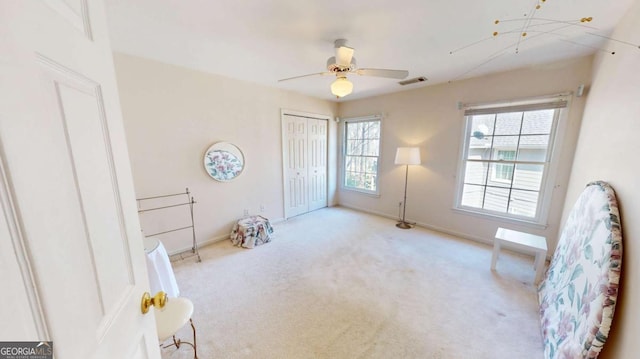 unfurnished room with baseboards, visible vents, ceiling fan, and carpet flooring