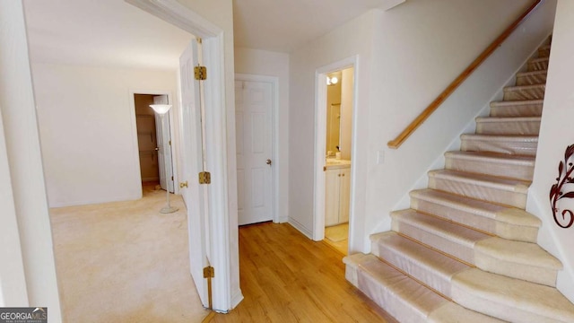 stairs featuring baseboards and wood finished floors