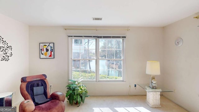 living area with visible vents, carpet, and plenty of natural light