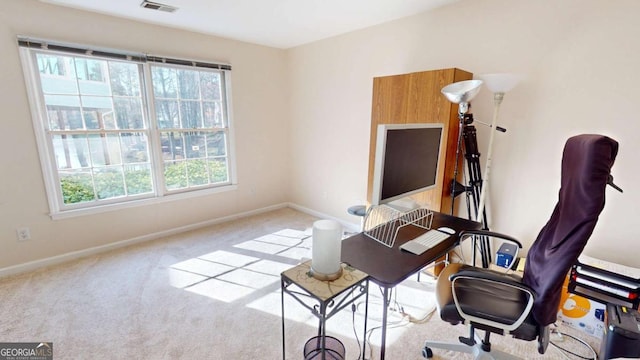 carpeted office featuring baseboards and visible vents