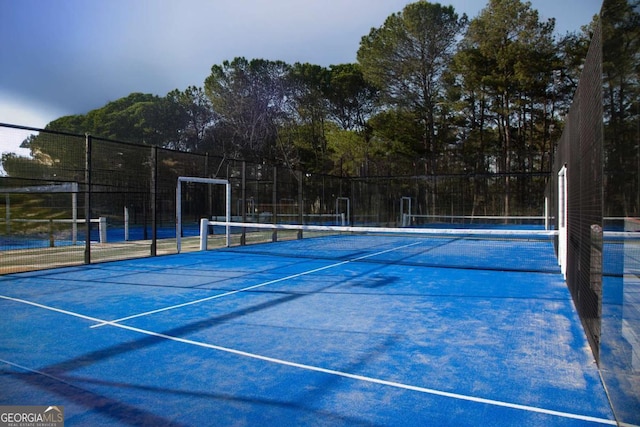 view of tennis court with fence