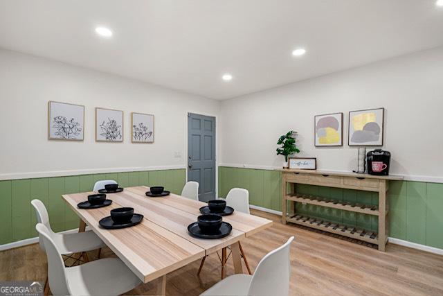 dining area with a wainscoted wall, recessed lighting, and wood finished floors
