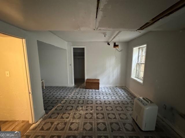 unfurnished room featuring baseboards and tile patterned floors