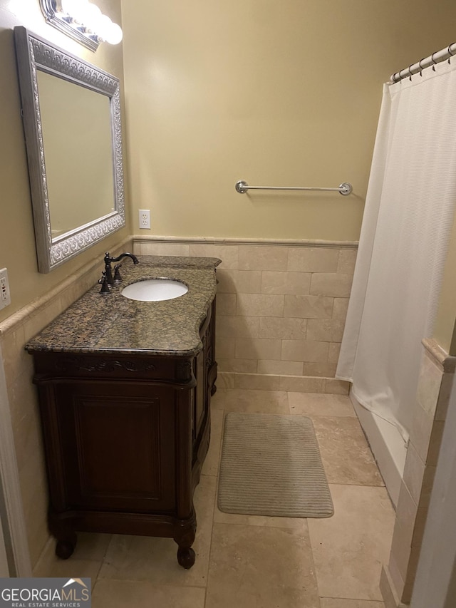 4 Baldwin Pl SE, Moultrie, GA 31788 - full bath with wainscoting, vanity, tile walls, and a shower with curtain
