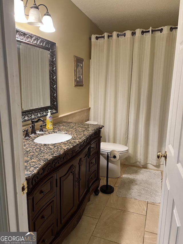 4 Baldwin Pl SE, Moultrie, GA 31788 - bathroom featuring toilet, vanity, tile patterned flooring, a chandelier, and a textured ceiling