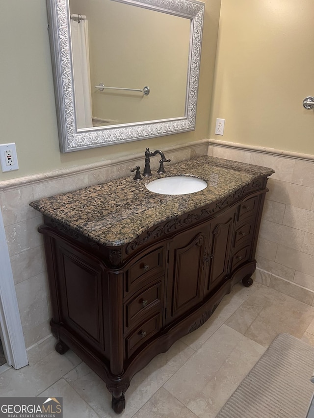 4 Baldwin Pl SE, Moultrie, GA 31788 - bathroom featuring tile walls, a wainscoted wall, and vanity