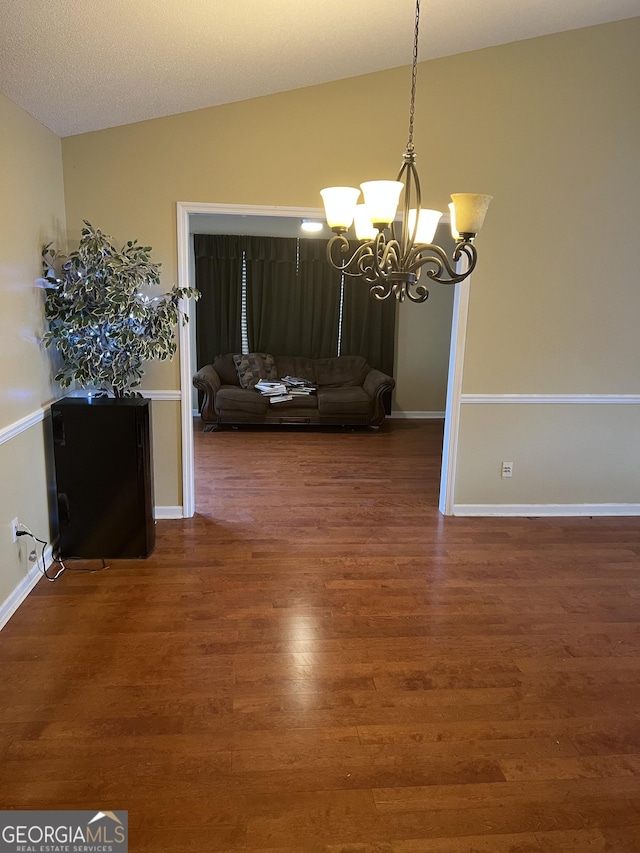 4 Baldwin Pl SE, Moultrie, GA 31788 - dining room featuring a chandelier, wood finished floors, lofted ceiling, and baseboards