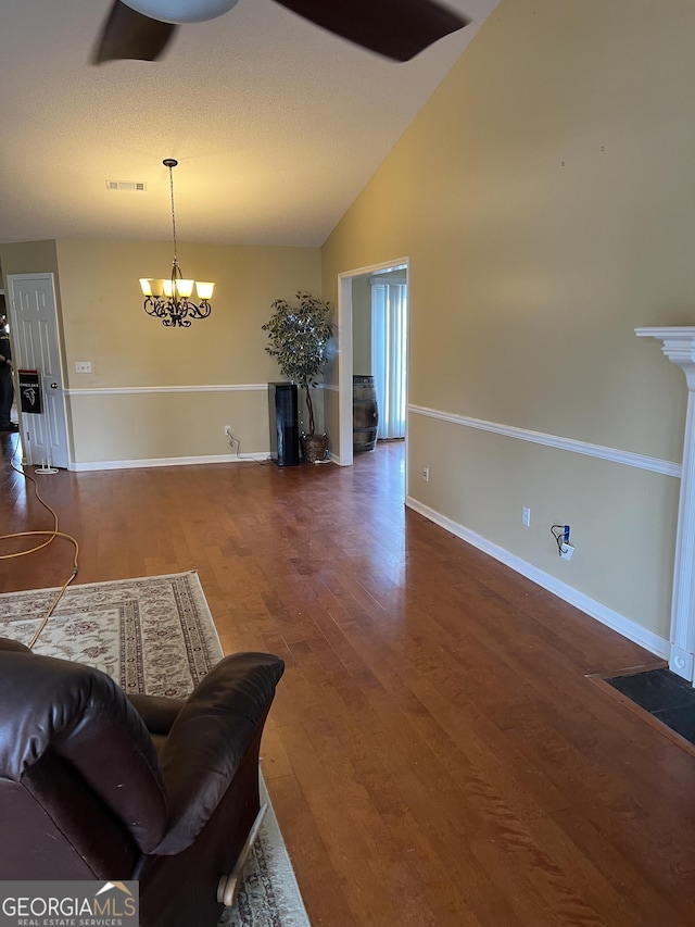 4 Baldwin Pl SE, Moultrie, GA 31788 - living room with a chandelier, wood finished floors, baseboards, and lofted ceiling