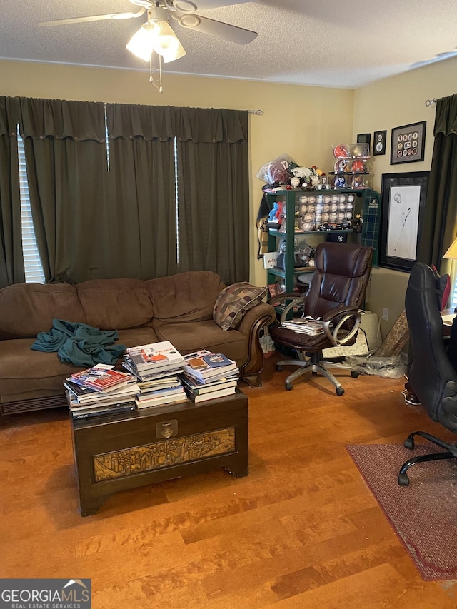 4 Baldwin Pl SE, Moultrie, GA 31788 - living room featuring wood finished floors, ceiling fan, and a textured ceiling