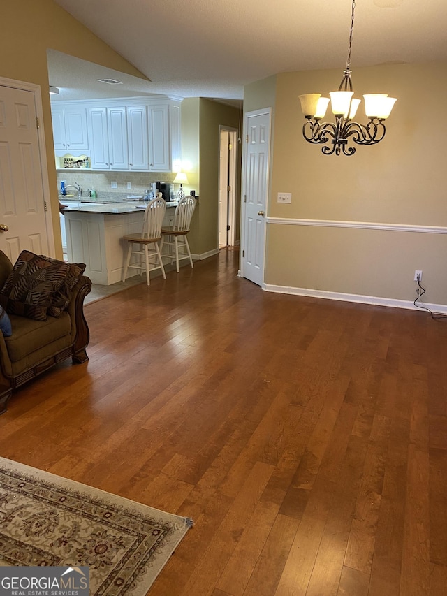 4 Baldwin Pl SE, Moultrie, GA 31788 - dining area featuring wood finished floors, a chandelier, and baseboards