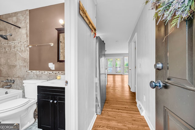 117 Foothills Dr, Cleveland, GA 30528 - full bathroom with wood finished floors, toilet, vanity, shower / bathtub combination, and tile walls