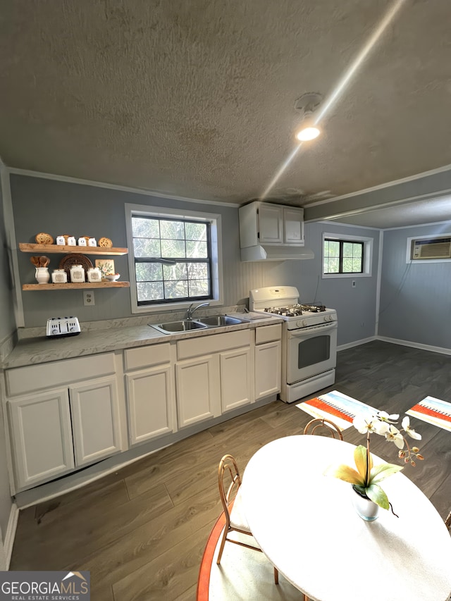1911 Park Ave S, Tifton, GA 31794 - kitchen featuring white range with gas cooktop, wood finished floors, white cabinetry, a sink, and a textured ceiling