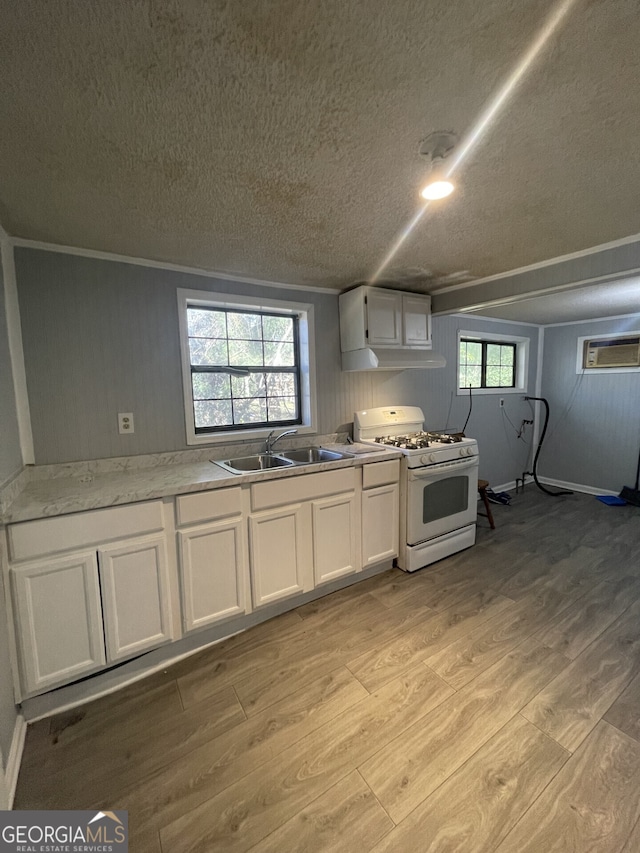 1911 Park Ave S, Tifton, GA 31794 - kitchen with white range with gas cooktop, a textured ceiling, light wood-style flooring, white cabinets, and a sink