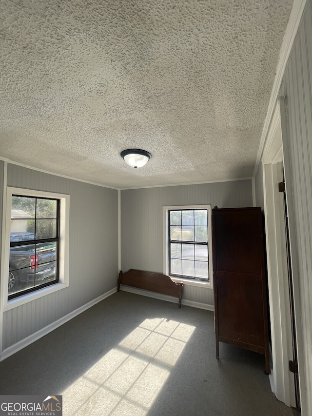 1911 Park Ave S, Tifton, GA 31794 - unfurnished bedroom with carpet, a textured ceiling, and crown molding