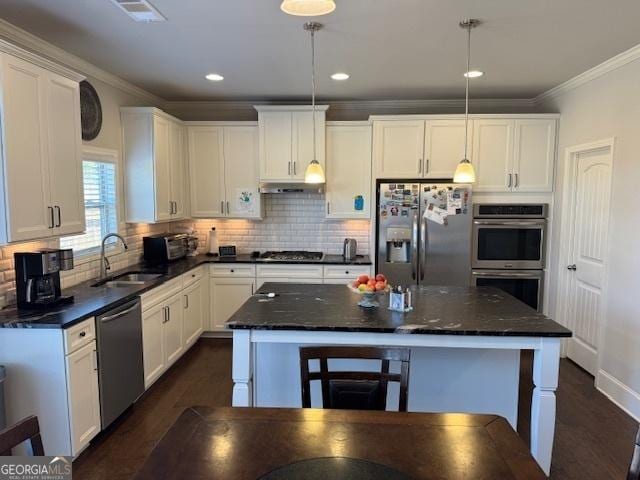 5530 Lacebark Pine Ct, Cumming, GA 30040 - kitchen with appliances with stainless steel finishes, white cabinetry, crown molding, tasteful backsplash, and dark wood-style floors