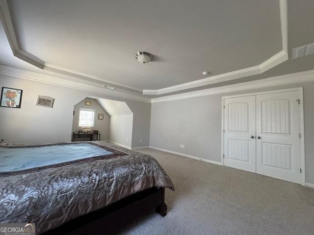 5530 Lacebark Pine Ct, Cumming, GA 30040 - carpeted bedroom featuring a raised ceiling, ornamental molding, arched walkways, and a closet