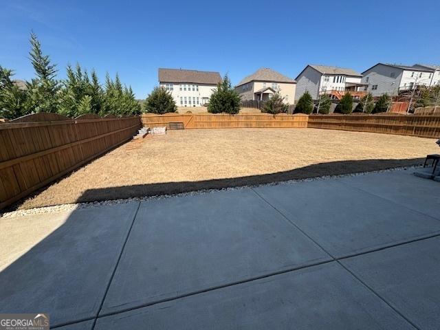 5530 Lacebark Pine Ct, Cumming, GA 30040 - fenced backyard with a residential view and a patio