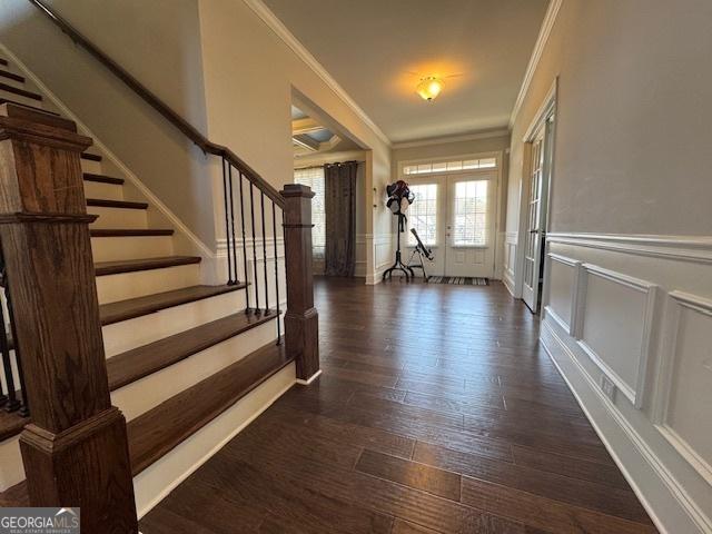 5530 Lacebark Pine Ct, Cumming, GA 30040 - foyer featuring crown molding, a decorative wall, stairway, dark wood-type flooring, and wainscoting