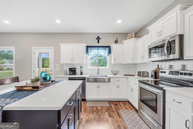 kitchen featuring light countertops, white cabinetry, appliances with stainless steel finishes, and a sink