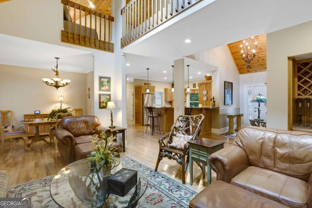 765 River Oaks Dr, Hayesville, NC 28904 - living area with high vaulted ceiling, light wood-style flooring, and a chandelier