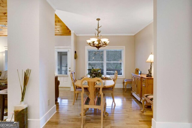 765 River Oaks Dr, Hayesville, NC 28904 - dining room featuring light wood finished floors, baseboards, a notable chandelier, and crown molding