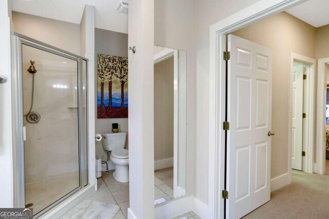 765 River Oaks Dr, Hayesville, NC 28904 - bathroom featuring tile patterned flooring, toilet, baseboards, a stall shower, and visible vents