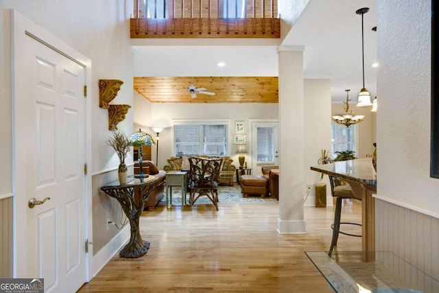 765 River Oaks Dr, Hayesville, NC 28904 - foyer featuring a high ceiling, a wainscoted wall, ceiling fan with notable chandelier, and wood finished floors