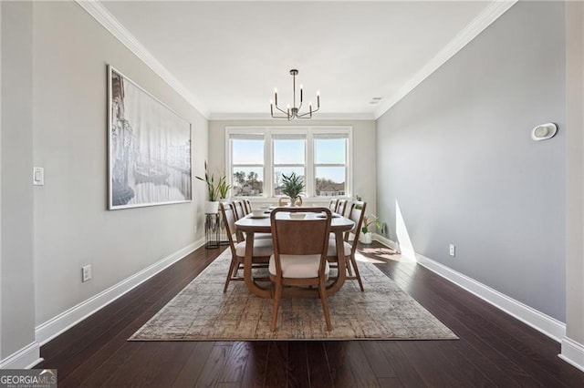 dining area featuring dark wood finished floors, an inviting chandelier, crown molding, and baseboards