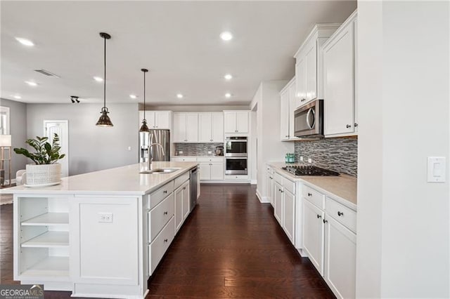 kitchen with white cabinets, open shelves, a sink, tasteful backsplash, and appliances with stainless steel finishes